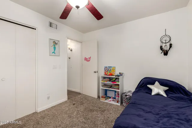 a view of bedroom with a ceiling fan