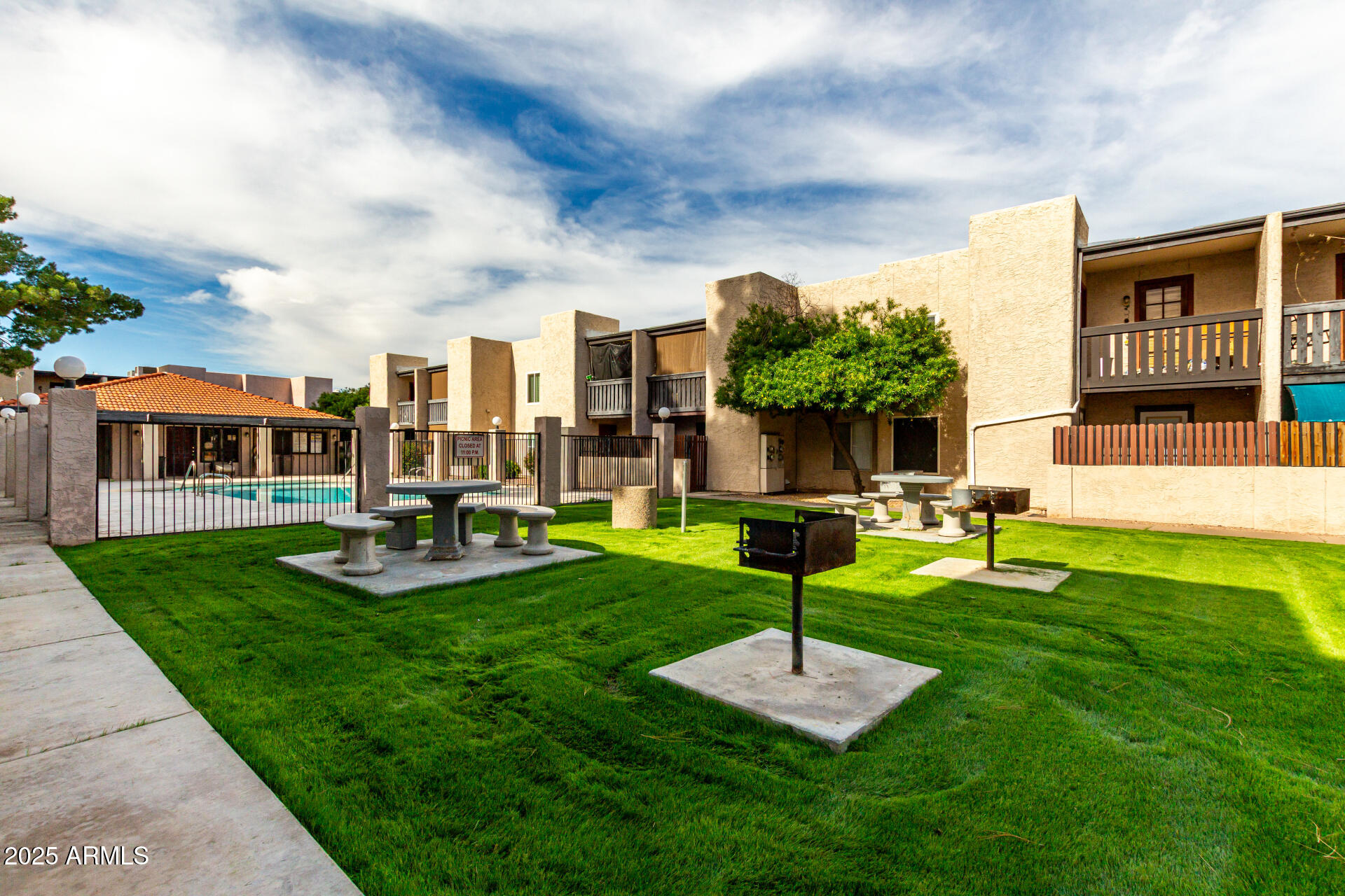 1927 East Hampton Avenue, Unit 129 Mesa, AZ 85204 - Photo 20 of 23 a view of a house with a swimming pool and a yard