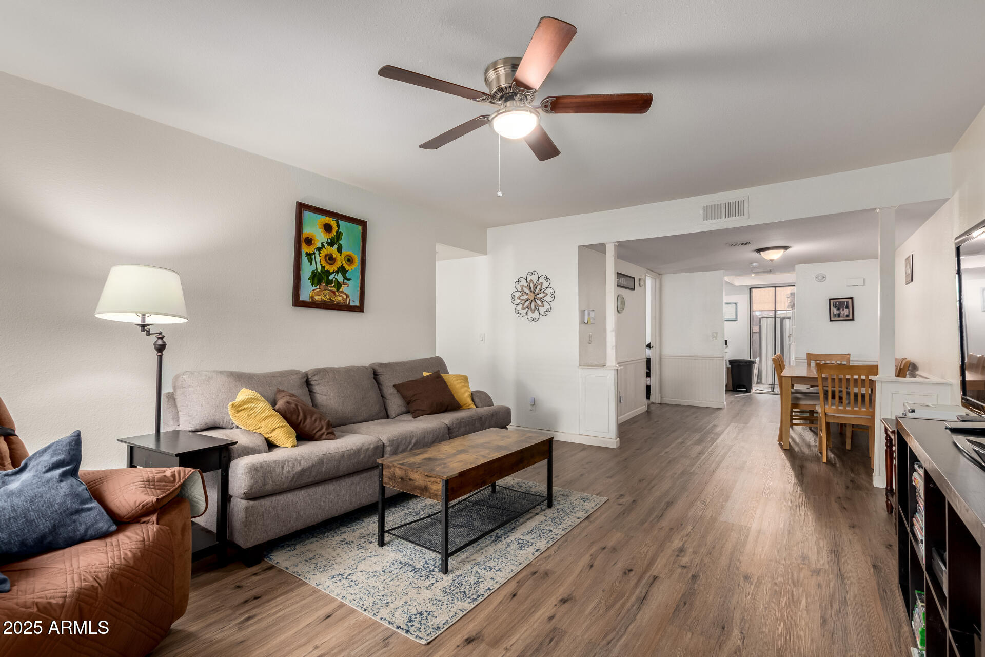 1927 East Hampton Avenue, Unit 129 Mesa, AZ 85204 - Photo 2 of 23 a living room with furniture and a wooden floor