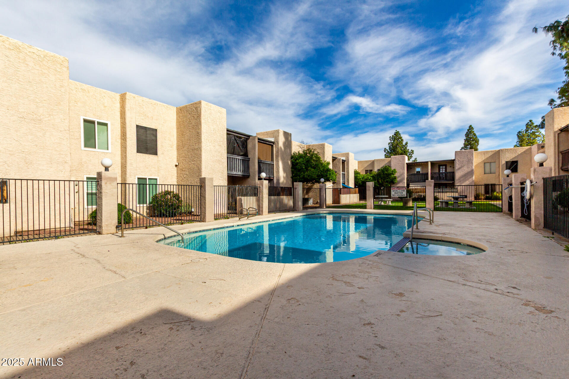 1927 East Hampton Avenue, Unit 129 Mesa, AZ 85204 - Photo 21 of 23 a view of a swimming pool with a lawn chairs