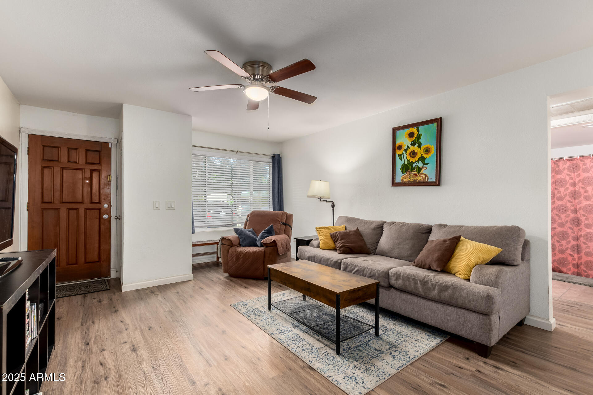 1927 East Hampton Avenue, Unit 129 Mesa, AZ 85204 - Photo 3 of 23 a living room with furniture and a flat screen tv