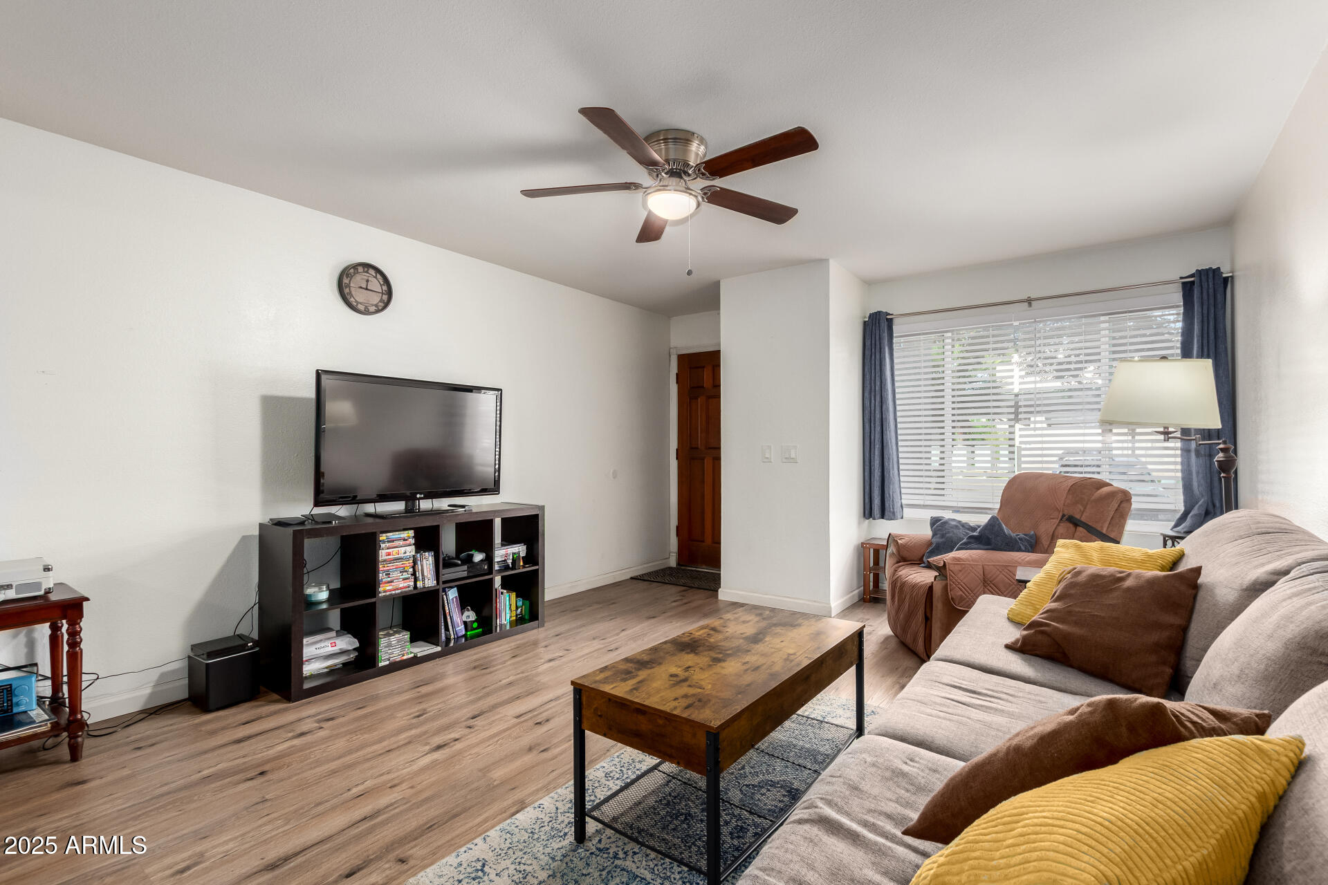 1927 East Hampton Avenue, Unit 129 Mesa, AZ 85204 - Photo 4 of 23 a living room with furniture and a flat screen tv