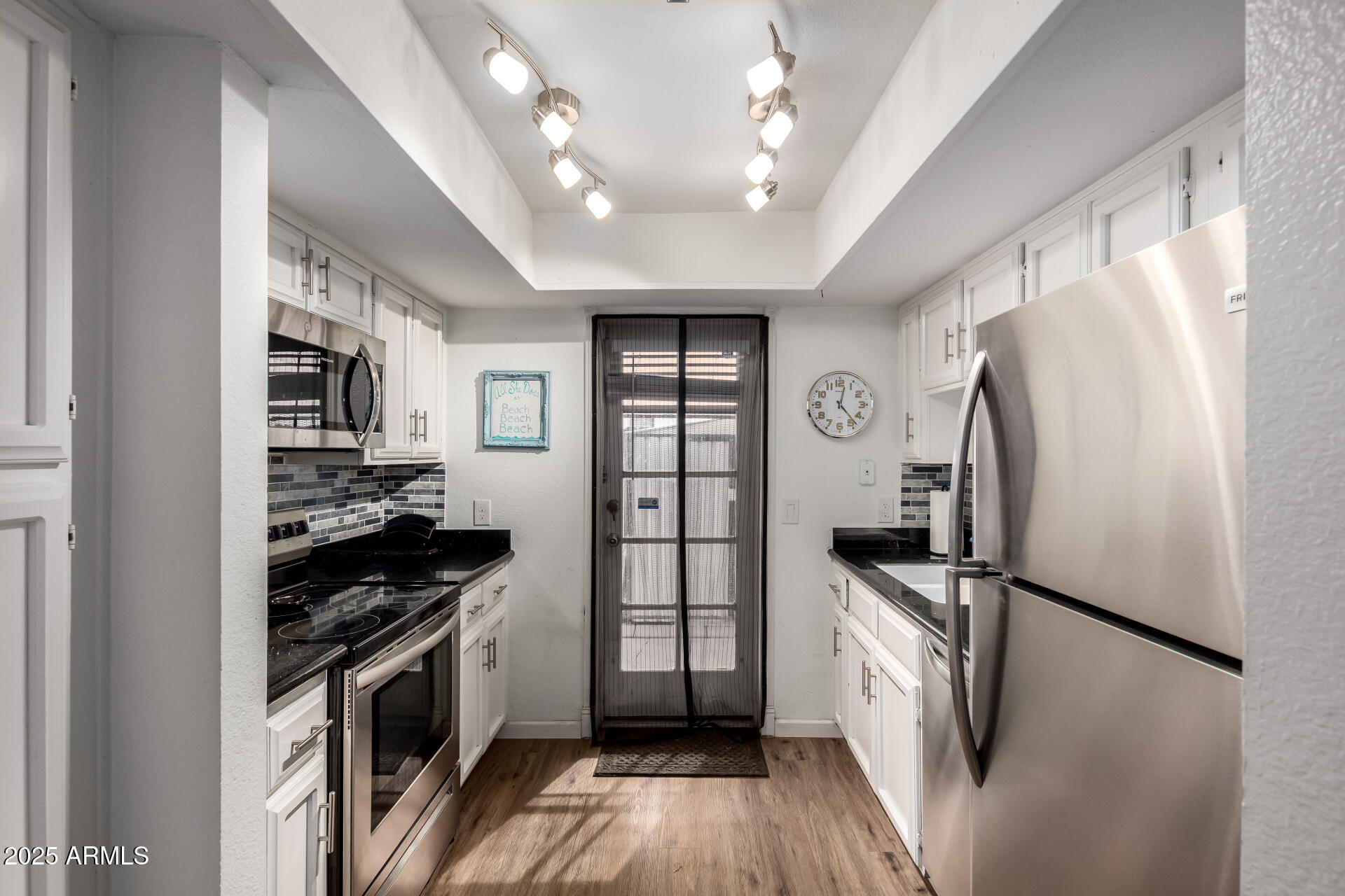 1927 East Hampton Avenue, Unit 129 Mesa, AZ 85204 - Photo 7 of 23 a kitchen with stainless steel appliances a refrigerator a stove a sink and a refrigerator