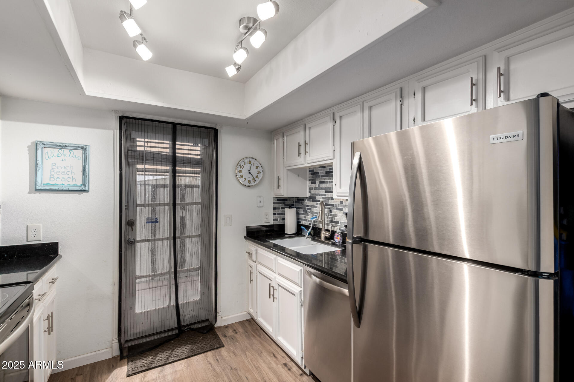 1927 East Hampton Avenue, Unit 129 Mesa, AZ 85204 - Photo 9 of 23 a kitchen with stainless steel appliances a refrigerator and a stove top oven