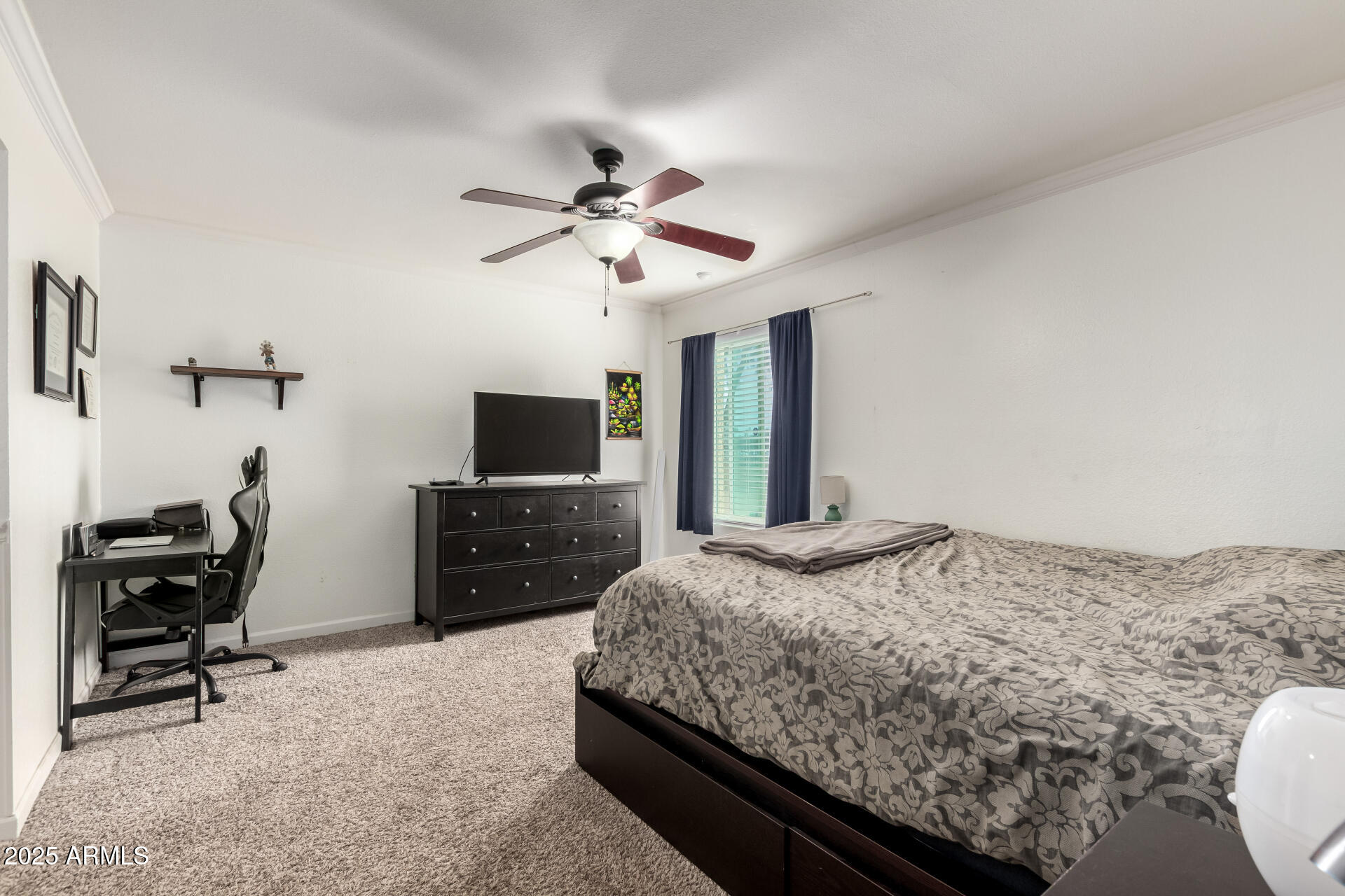 1927 East Hampton Avenue, Unit 129 Mesa, AZ 85204 - Photo 10 of 23 a bedroom with a bed a computer on a desk and chair