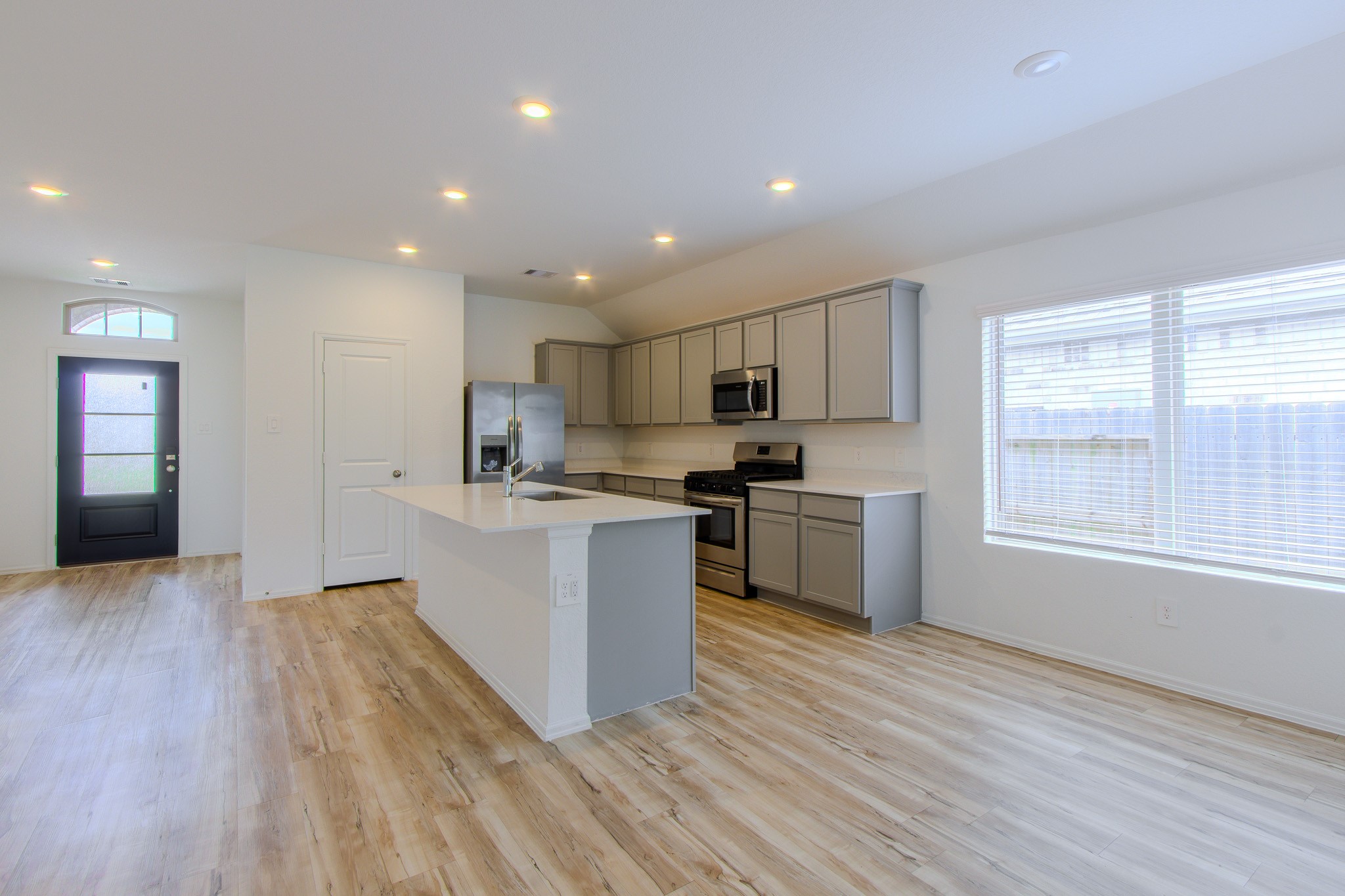 3113 Catalonion Court Conroe, TX 77301 - Photo 9 of 45 a kitchen with a refrigerator and a stove top oven