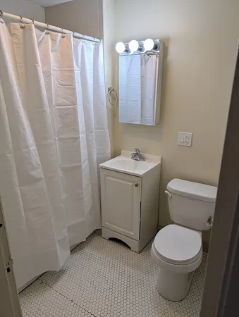 a white toilet sitting next to a bathroom sink