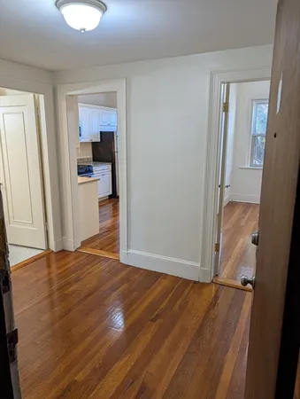 a view of a room with wooden floor and a bathroom