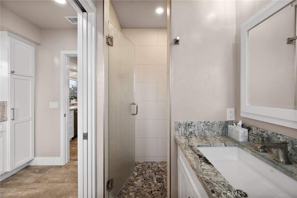 1612 Bellevue Road Redlands, CA 92373 - Photo 11 of 31 a bathroom with a granite countertop tub sink and shower