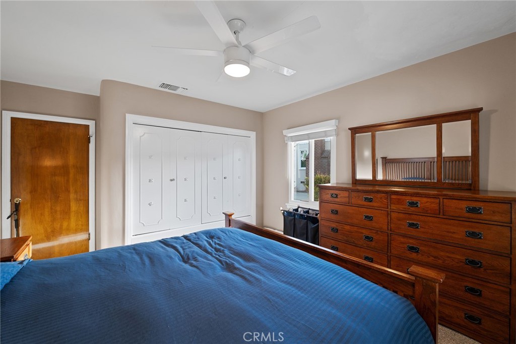 1612 Bellevue Road Redlands, CA 92373 - Photo 21 of 31 a bedroom with a bed and a mirror on dresser