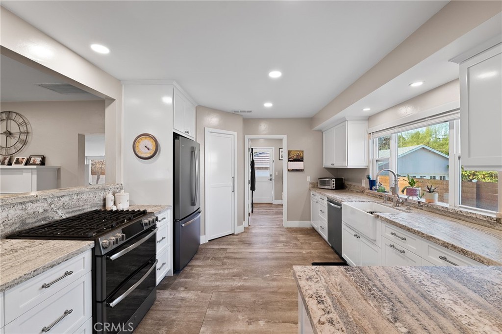 1612 Bellevue Road Redlands, CA 92373 - Photo 7 of 31 a large kitchen with stainless steel appliances granite countertop a stove a sink dishwasher and a refrigerator