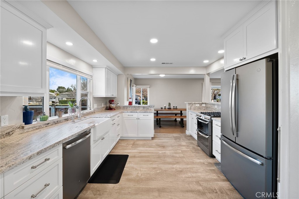 1612 Bellevue Road Redlands, CA 92373 - Photo 8 of 31 a kitchen with refrigerator and cabinets