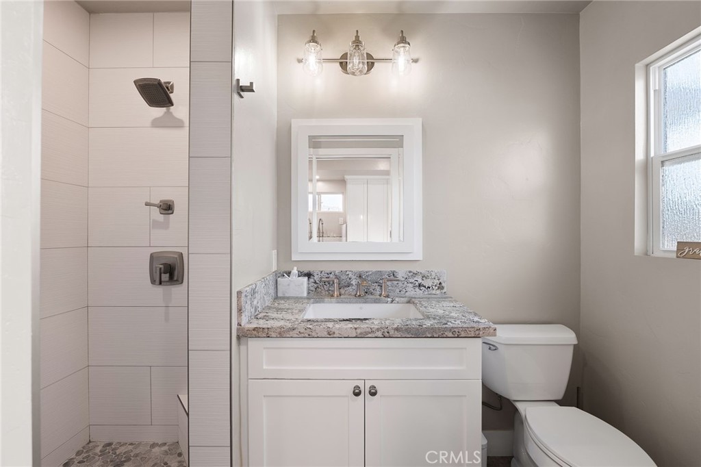 1612 Bellevue Road Redlands, CA 92373 - Photo 10 of 31 a bathroom with a granite countertop sink toilet and shower
