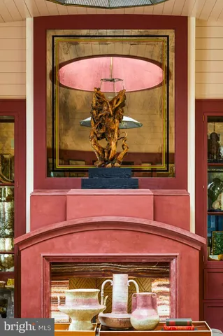 a dining room with furniture a chandelier and wooden floor