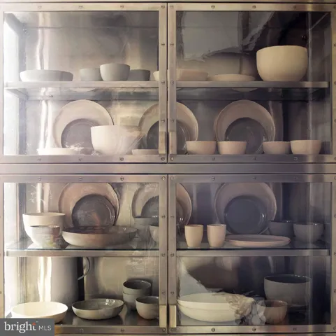 a living room with furniture a lamp and a window