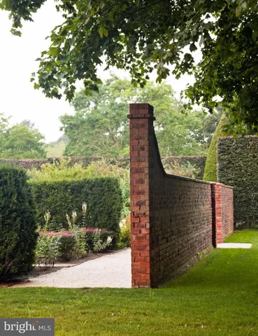 a view of a wooden door with a door and a painting on the wall