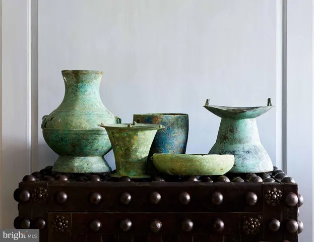 a living room with furniture a chandelier and a table