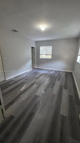 a utility room with a sink a vanity and a mirror