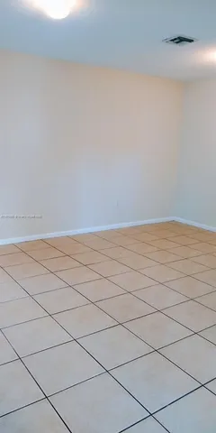 a kitchen with granite countertop wood cabinets and white appliances