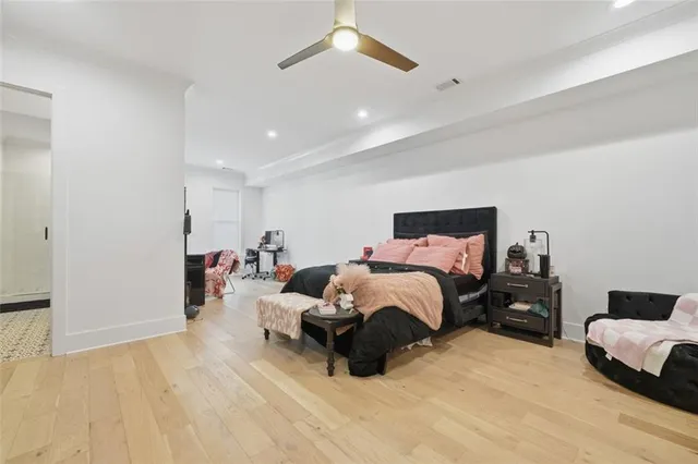 a kitchen with cabinets wooden floor and stainless steel appliances