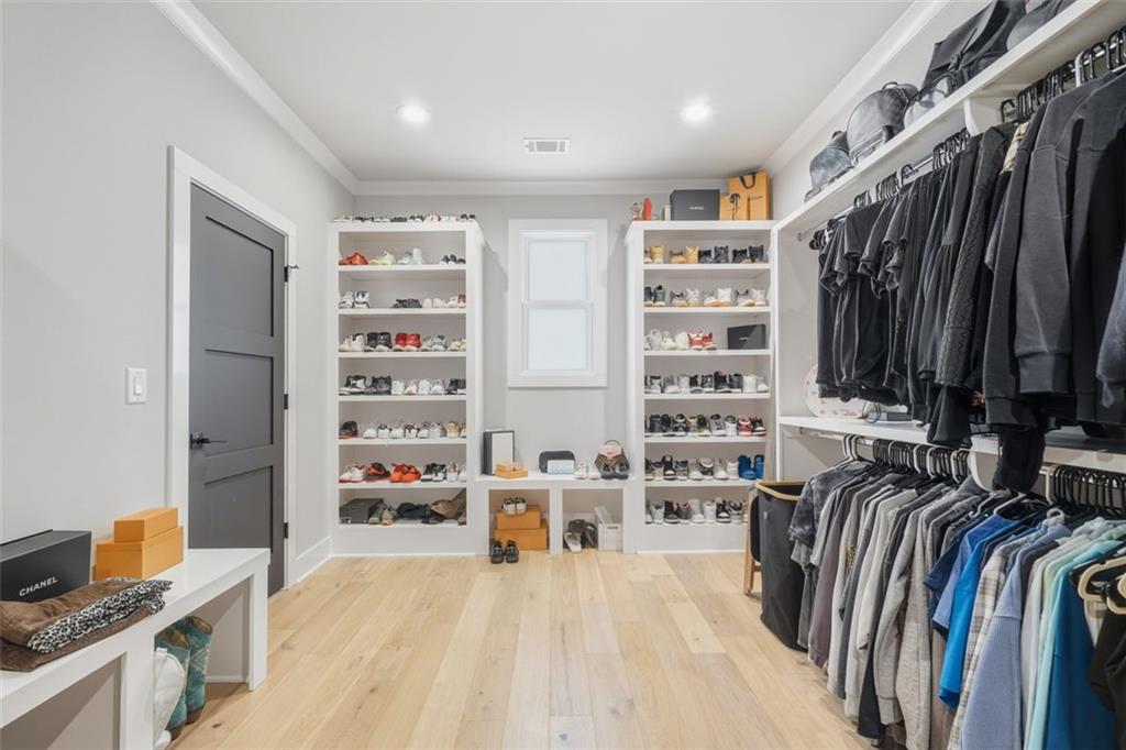 116 Owens Mill Place Canton, GA 30115 - Photo 36 of 65 a view of walk in closet with clothes and shoes