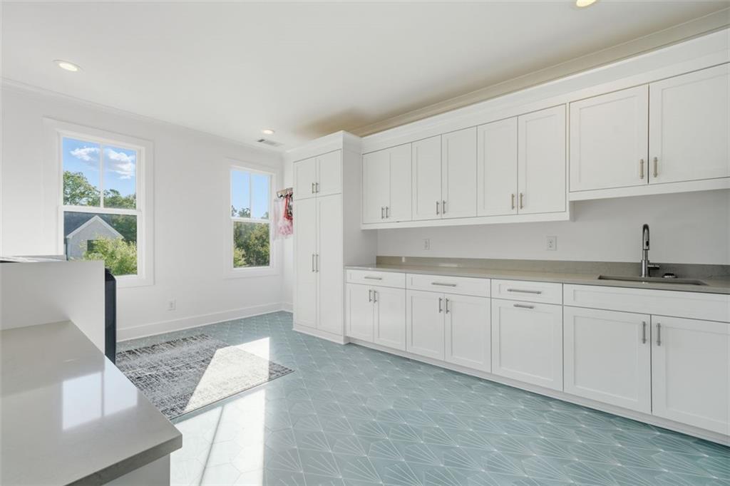 116 Owens Mill Place Canton, GA 30115 - Photo 49 of 65 a kitchen with granite countertop white cabinets and sink