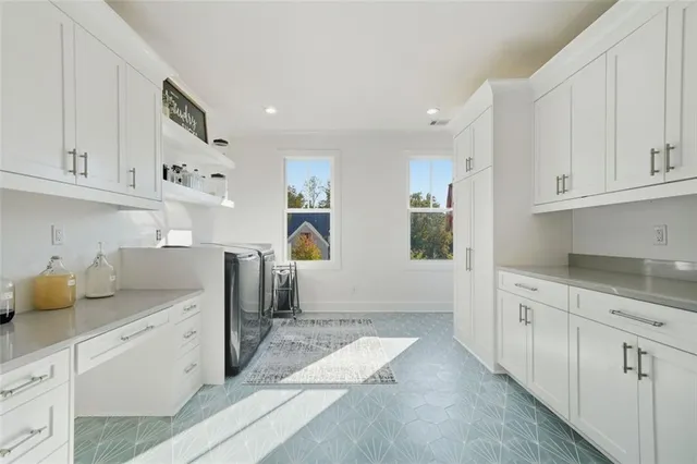 a front view of a house with yard and green space