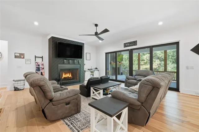 a kitchen with stainless steel appliances kitchen island granite countertop a table chairs sink and cabinets