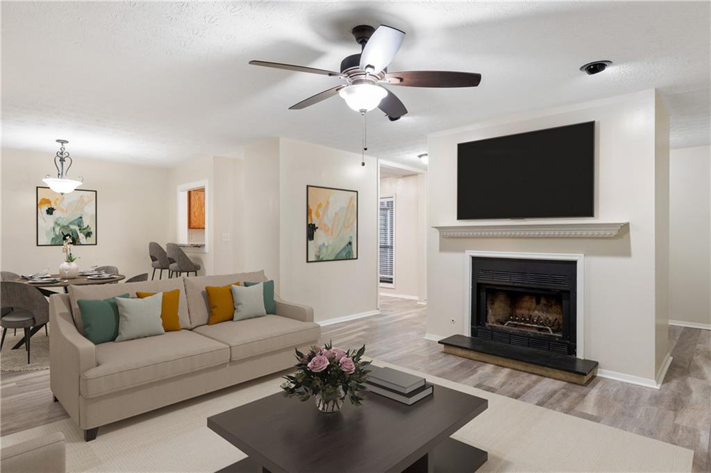 905 Wynnes Ridge Circle Southeast Marietta, GA 30067 - Photo 1 of 1 a living room with furniture a fireplace and a flat screen tv