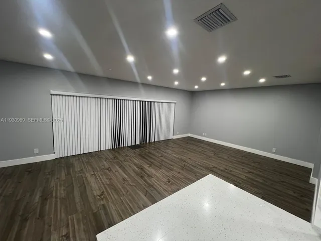 an empty room with wooden floor
