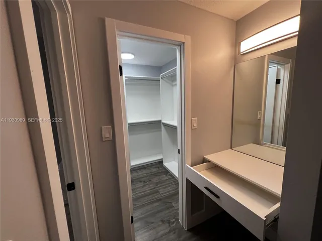 a bathroom with a granite countertop sink toilet a mirror and shower