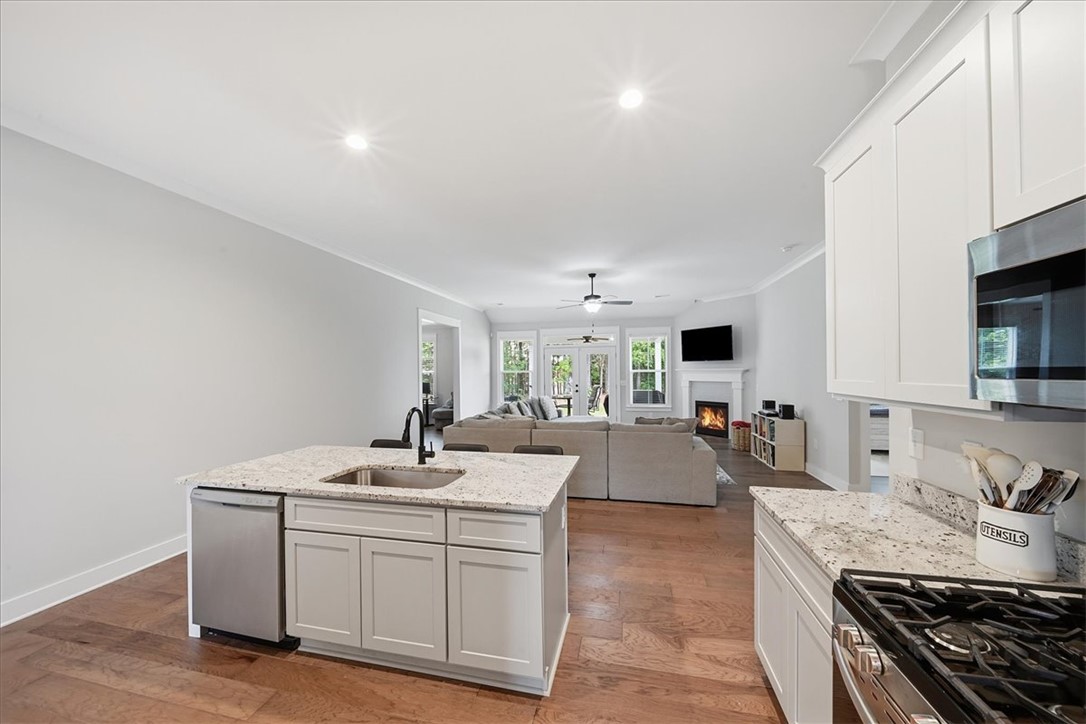 214 Timothy Court Anderson, SC 29621 - Photo 42 of 43 An open concept floorplan seamlessly connects the well-appointed kitchen to the inviting family room with a cozy fireplace.