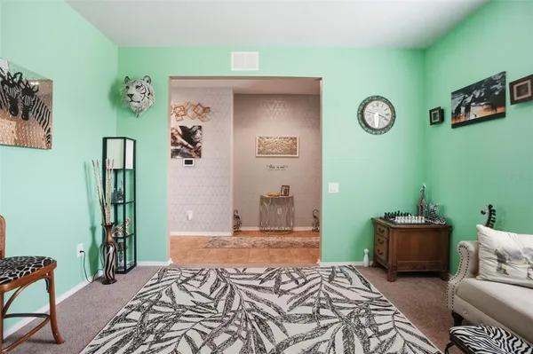 a bed room with a bed and a chair