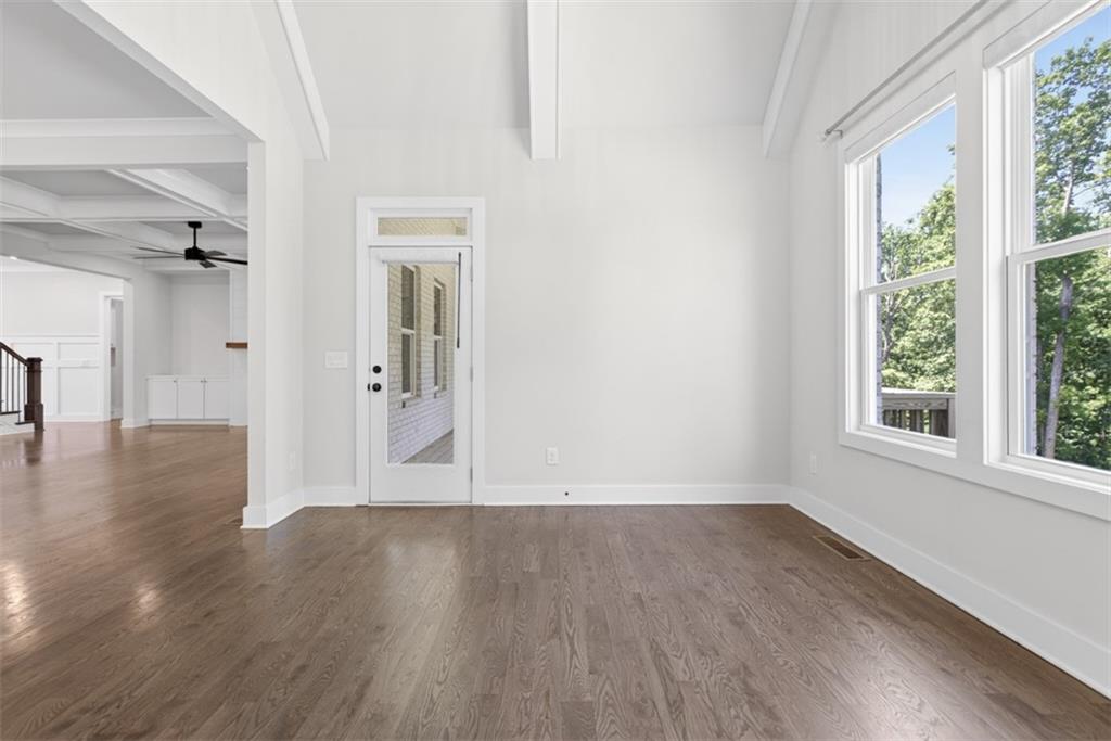 3528 North Bogan Road Buford, GA 30519 - Photo 18 of 79 a view of an empty room with wooden floor and a window