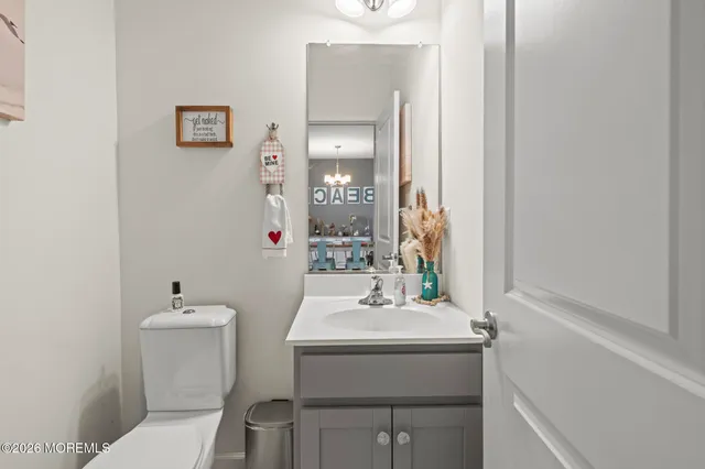 a bathroom with a sink toilet and a mirror