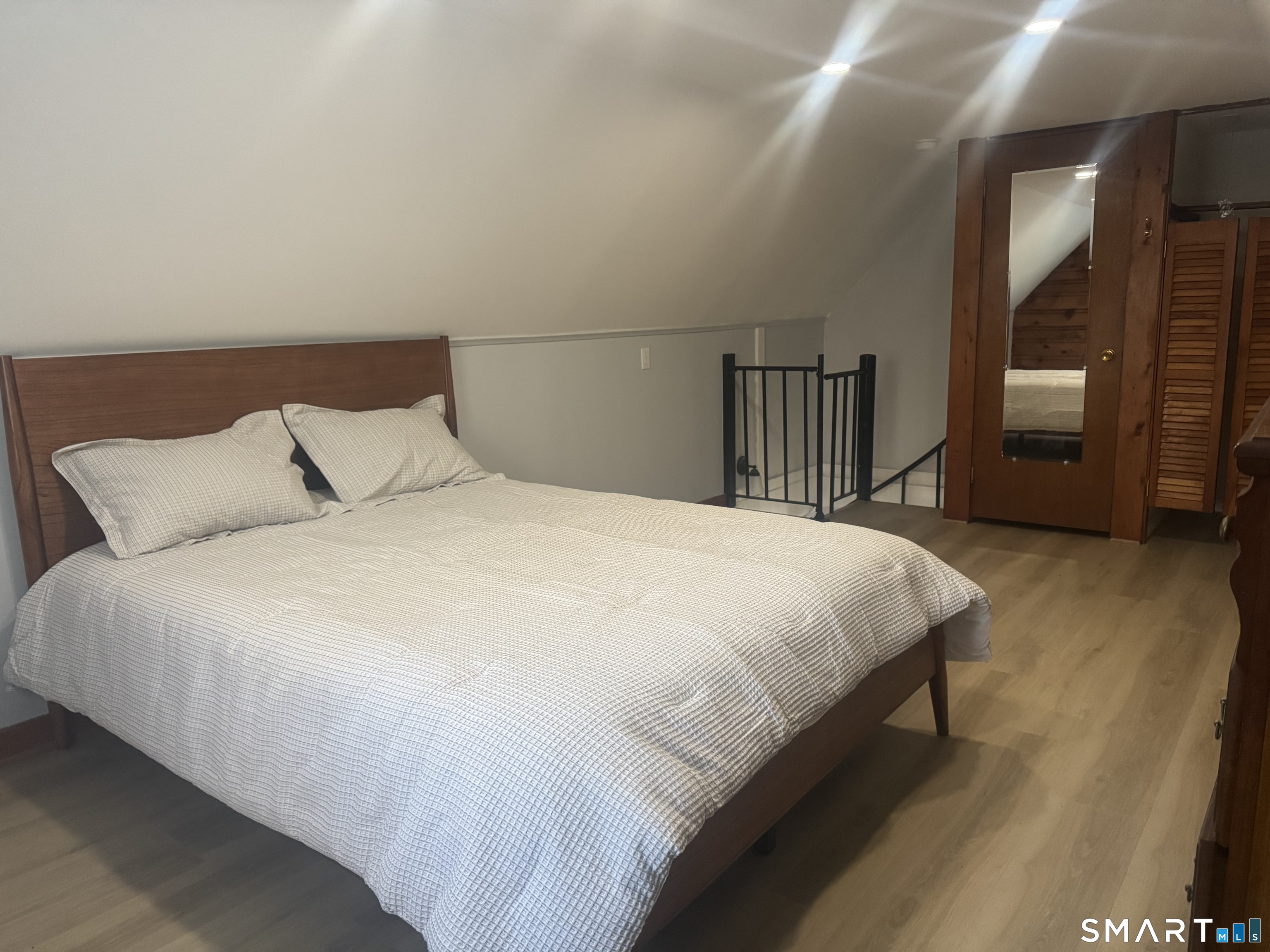 352 Hotchkiss Road Orange, CT 06477 - Photo 12 of 12 a large bed sitting in a bedroom and night stand