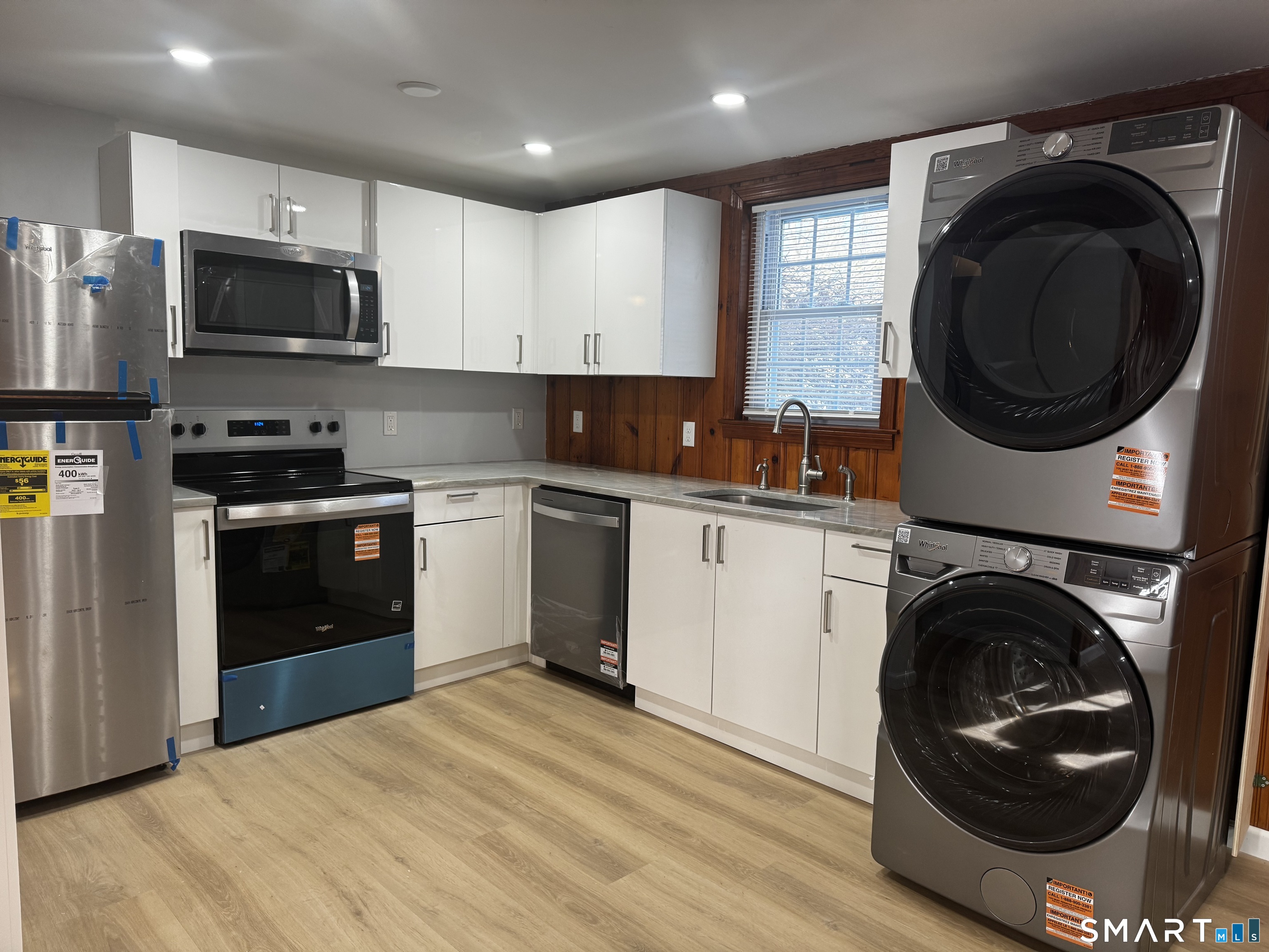 352 Hotchkiss Road Orange, CT 06477 - Photo 4 of 12 a kitchen with a sink a washer and dryer
