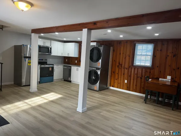 a kitchen with a refrigerator and a stove top oven