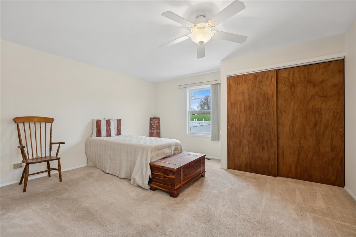 612 White Pine Road Buffalo Grove, IL 60089 - Photo 12 of 24 a spacious bedroom with a bed and a chandelier