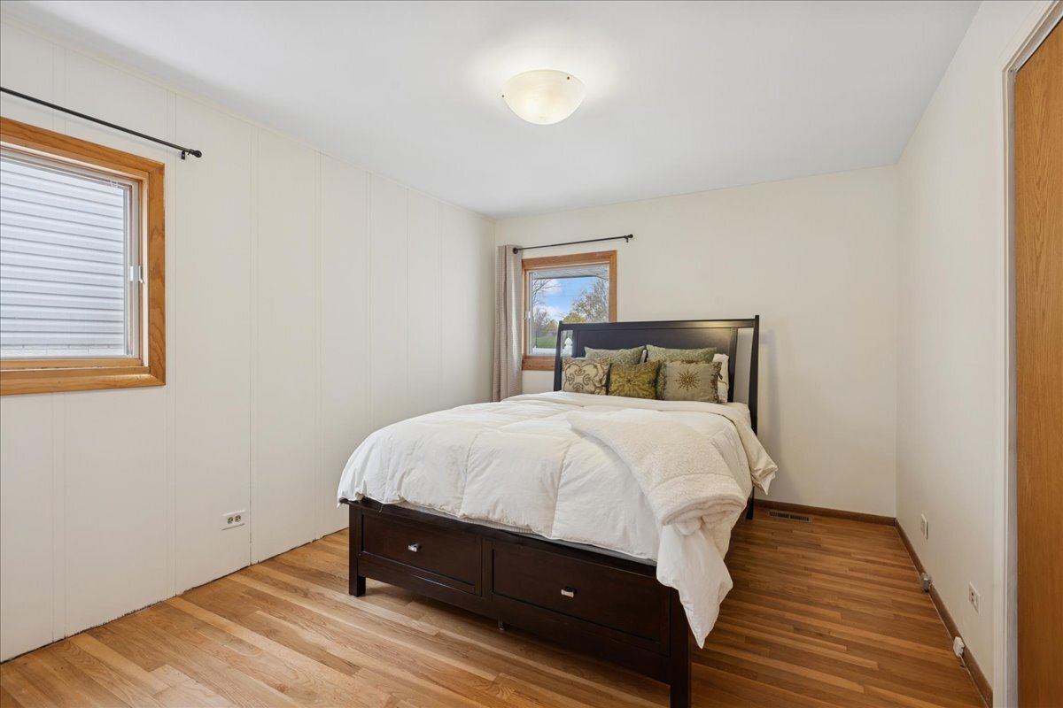 612 White Pine Road Buffalo Grove, IL 60089 - Photo 15 of 24 a bedroom with a bed and wooden floor