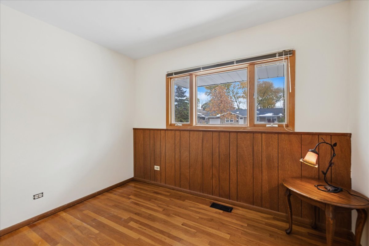 612 White Pine Road Buffalo Grove, IL 60089 - Photo 17 of 24 a view of an empty room with wooden floor and a window