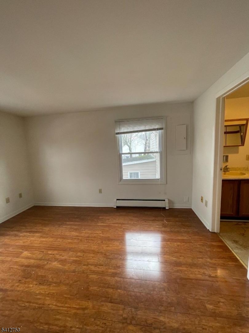 278 Morris Street Stirling, NJ 07980 - Photo 11 of 20 an empty room with wooden floor and windows