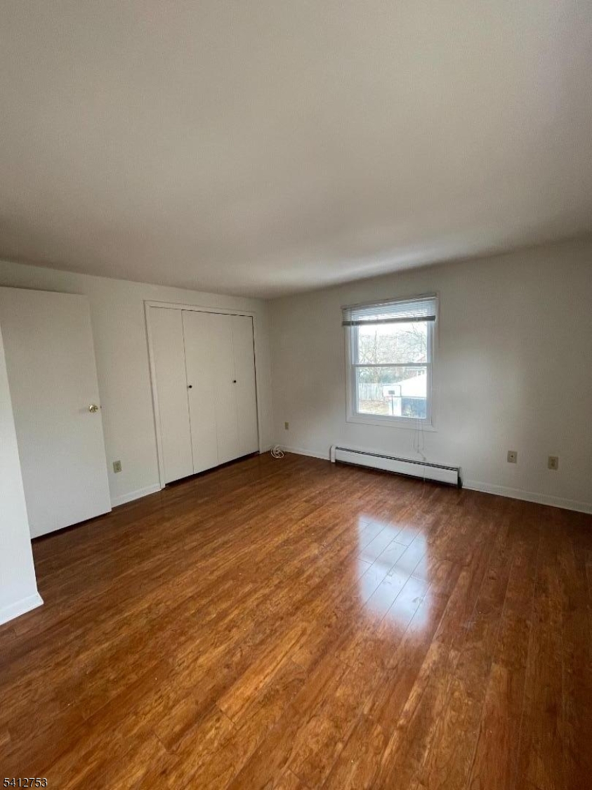 278 Morris Street Stirling, NJ 07980 - Photo 12 of 20 an empty room with wooden floor and windows