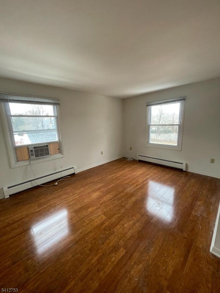 278 Morris Street Stirling, NJ 07980 - Photo 18 of 20 an empty room with wooden floor and windows