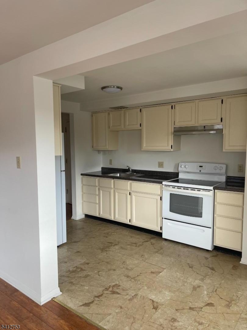 278 Morris Street Stirling, NJ 07980 - Photo 5 of 20 a kitchen with granite countertop white cabinets and white stainless steel appliances