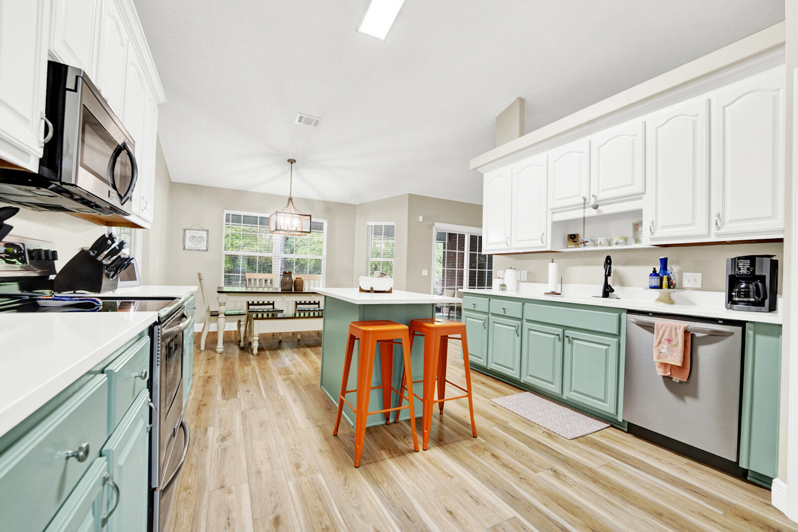 304 Greyfox Circle Crestview, FL 32536 - Photo 11 of 49 a kitchen with stainless steel appliances granite countertop a stove top oven a sink dishwasher and white cabinets with wooden floor