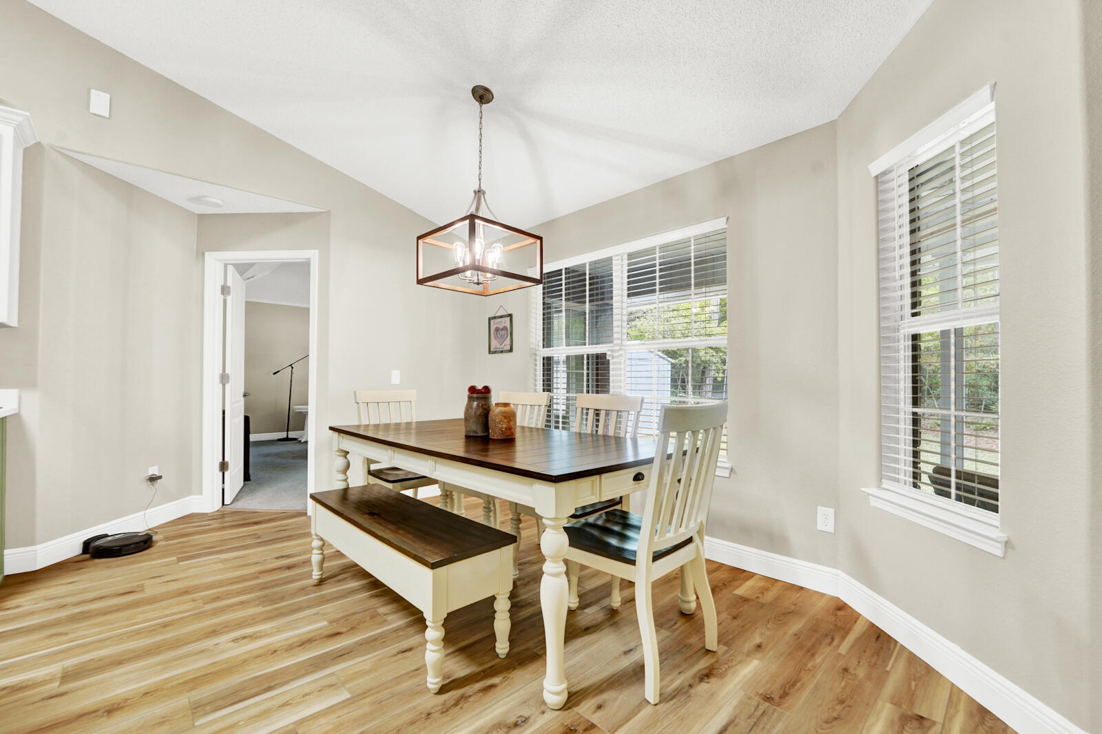 304 Greyfox Circle Crestview, FL 32536 - Photo 15 of 49 a dining room with wooden floor a chandelier a wooden table and chairs