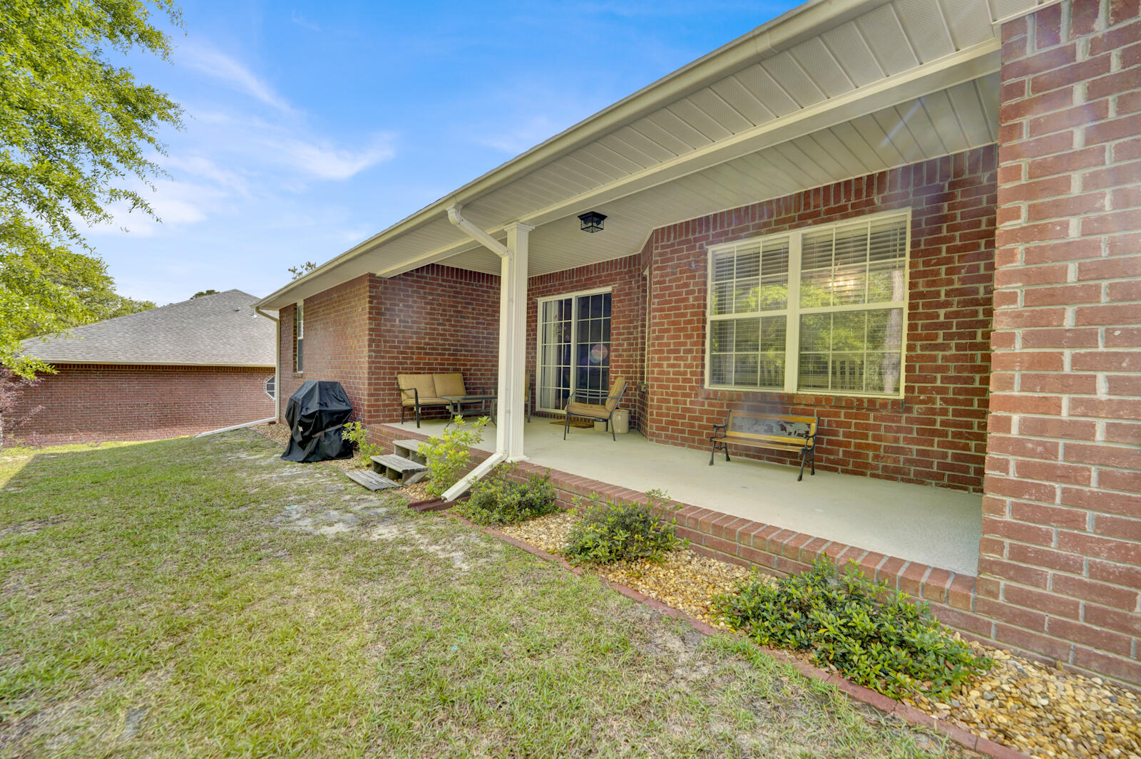 304 Greyfox Circle Crestview, FL 32536 - Photo 39 of 49 a view of a house with backyard sitting area and garden
