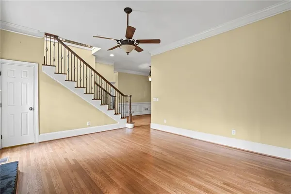 a view of a room with wooden floor and white walls