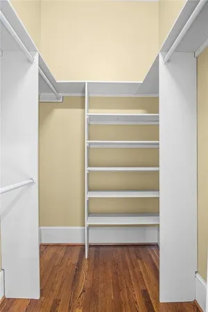 a view of walk in closet with empty racks